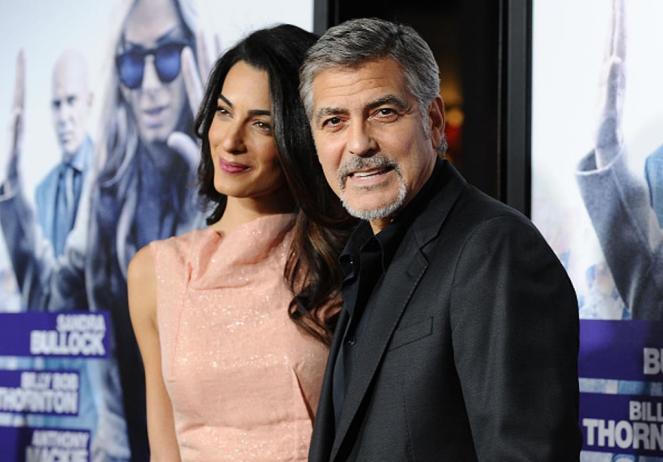 HOLLYWOOD, CA - OCTOBER 26: Amal Clooney and George Clooney attend the premiere of