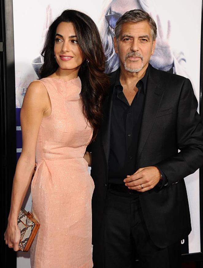 HOLLYWOOD, CA - OCTOBER 26: Amal Clooney and George Clooney attend the premiere of