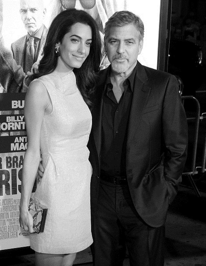 HOLLYWOOD, CA - OCTOBER 26: (EDITORS NOTE: Image has been converted to black and white.) Actor George Clooney and wife Amal Clooney arrive at the premiere of Warner Bros. Pictures'