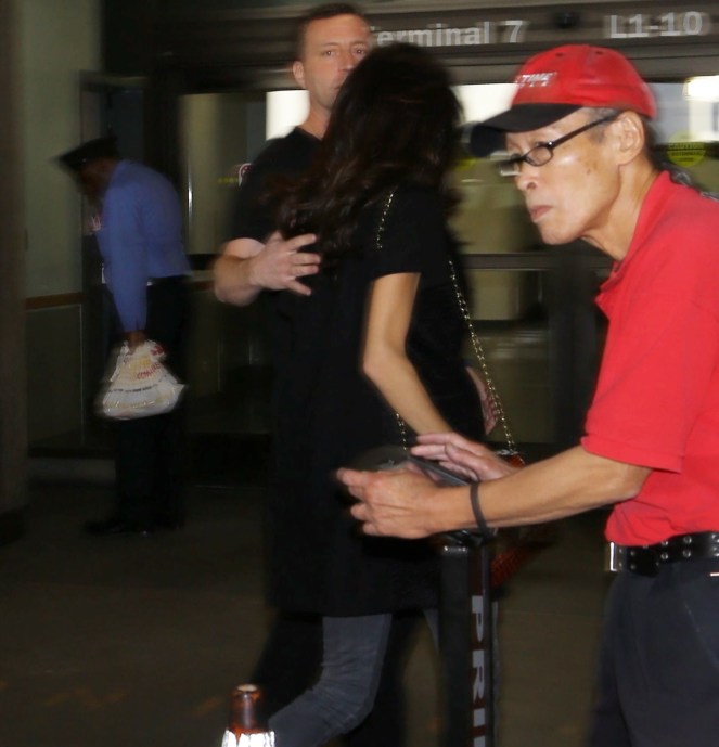 Please contact X17 before any use of these exclusive photos - x17@x17agency.com George Clooney and Amal Alamuddin catch a flight at LAX. George is wearing an Casamigos tee shirt promoting the brand of tequilla that he owns with Rande Gerber and he is carrying his European passport November 8, 2015 X17online.com