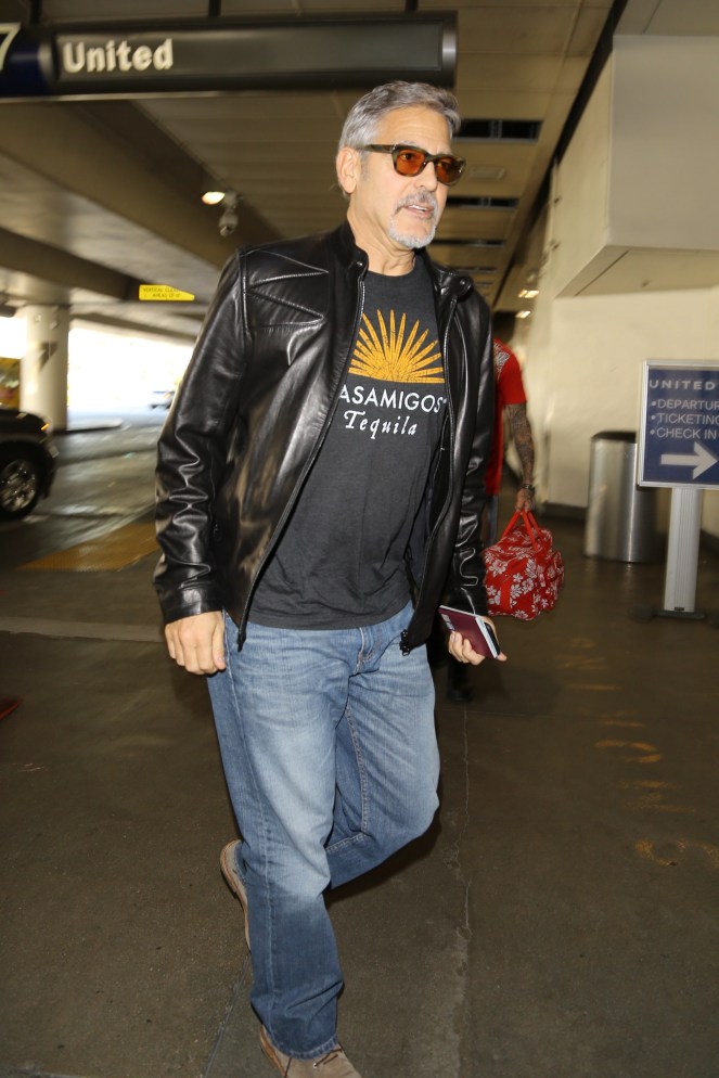 Please contact X17 before any use of these exclusive photos - x17@x17agency.com George Clooney and Amal Alamuddin catch a flight at LAX. George is wearing an Casamigos tee shirt promoting the brand of tequilla that he owns with Rande Gerber and he is carrying his European passport November 8, 2015 X17online.com