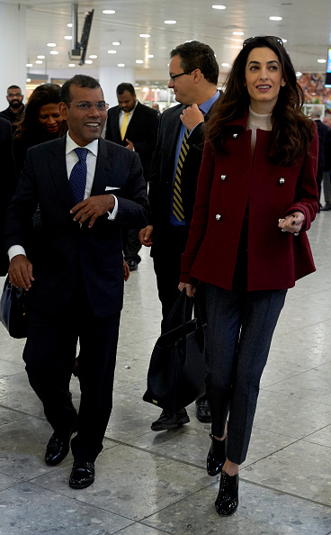 Former Maldives president Mohamed Nasheed (L) and his British lawyer Amal Clooney walk after Nasheed arrived at Heathrow airport in London on Janurary 21, 2016. Nasheed left the Maldives on Monday after the Indian Ocean islands' government granted him prison leave for urgent surgery. Nasheed, became the first democratically elected president of the Maldives in 2008 and served for four years before he was toppled in what he called a coup backed by the military and police. He was sentenced to 13 years in jail on terrorism charges relating to the arrest of an allegedly corrupt judge in 2012, when he was still in power. AFP PHOTO / NIKLAS HALLE'N / AFP / NIKLAS HALLE'N (Photo credit should read NIKLAS HALLE'N/AFP/Getty Images)